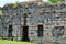 Ruins of an old stone house. Windows without glass.