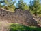 Ruins of an old stone wall located in the midst of a forest