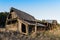 Ruins of an old wooden barn made from rustic logs and planks