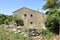 Ruins of once beautiful big house in the desert mountain village of The Old Perithia Ano Palea Perithia, Corfu Island, Greece, E