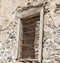 The ruins, the ruins of the destroyed castle fortress wall with a window with iron bars.