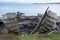 Ruins of small boat on the beach at Polbain, north of Ullapool. In background, view of the Summer Isles, Scotland