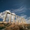 Ruins of the temple of Poseidon at Cape Sounio under blue sky, G
