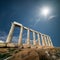 Ruins of the temple of Poseidon at Cape Sounion under the sun, Gr
