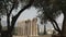 Ruins of the temple of zeus framed by olive trees in athens, greece