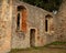 Ruins of wall with arched windows and doorway in church ruins. Colchester, Essex, UK - July 26th 2019