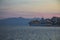 Ð¡ruise liner at the port of Saranda, Albania in the evening with the lights on, smoke from the pipes