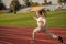 The rule in running is just run. Energetic girl run on running track. Sports school