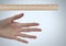 Ruler measuring size of long hand and fingers