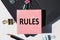 RULES note is written on a paper sticker on a laptop keyboard