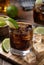 Rum and cola cocktail with sliced lime