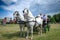 RUMA, SERBIA - JUNE 25, 2023: Selective blur on men, coachmen, driving a stagecoach fiacre, a hacnkey cab driven by two white