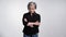 Ruminating adult woman with gray hair showing facial expressions posing in studio on a white background in casual