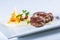 Rump steak. Close up Tender Grilled Beef Meat on White Plate with vegetable decoration.