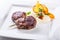 Rump steak. Close up Tender Grilled Beef Meat on White Plate with vegetable decoration.