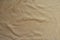 Rumpled beige jersey fabric from above