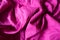 Rumpled bright fuchsia colored linen fabric