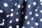 Rumpled dark blue and white cotton with polka dot pattern
