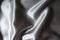 Rumpled glossy gray polyester satin fabric