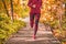 Run path woman running in forest park nature outdoors fitness workout on boardwalk in autumn fall foliage wearing red