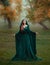 Runaway princess with red blond long hair dressed in a green emerald expensive velvet royal cloak-dress with a precious