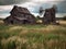 Rundown barn wooden windmill in background