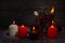 Rune Kenaz. A composition of burning candles, an old leather bag for Scandinavian runes