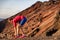 Runner athlete getting ready for training cardio exercise tying running shoes lace preparing for outdoor trail race in mountain