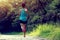 Runner athlete running on forest trail