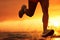 Runner athlete running at sunrise seaside. woman fitness jogging workout wellness concept, Running at the Beach, close up of leg,