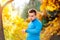 Runner in autumn nature measuring time with his watch