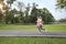 A runner caucasian couple is jogging in the park during summer season healthy or sport concept