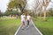 A runner caucasian couple is jogging in the park during summer season healthy or sport concept