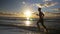 Runner doing workout on a beautiful beach at sunrise - slow motion