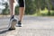 Runner feet running on road closeup on shoe. Woman fitness sunrise jog workout welness concept. Young fitness woman runner athlete