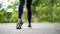 Runner feet running on road closeup on shoe. Young fitness woman runner athlete running at road. Athlete runner feet running on ro