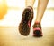 Runner feet running on road closeup on shoes