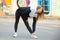 Runner girl stretching before morning jogging