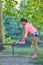 Runner girl tying laces shoes at the bench