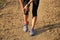 Runner hold her sports injured knee on dirt road