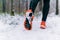 Runner legs while jogging in winter closeup