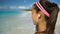 Runner Listening To Music Running Exercising On Beach Putting Headhones in ear