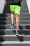 Runner man athlete running up the stairs on hiit high intensity interval training city run. Jogging jogger climbing staircase