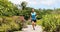 Runner man running on park path exercising on beautiful summer day