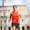 Runner man running at Rome marathon near Colosseum