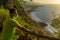 Runner rests on a viewpoint overlooking the beach.