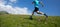 Runner running on mountain meadow