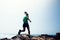 Runner running at rocky mountain top