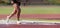 Runner running through the steeplechase water bake on a running track