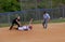 Runner slides into base in a softball game